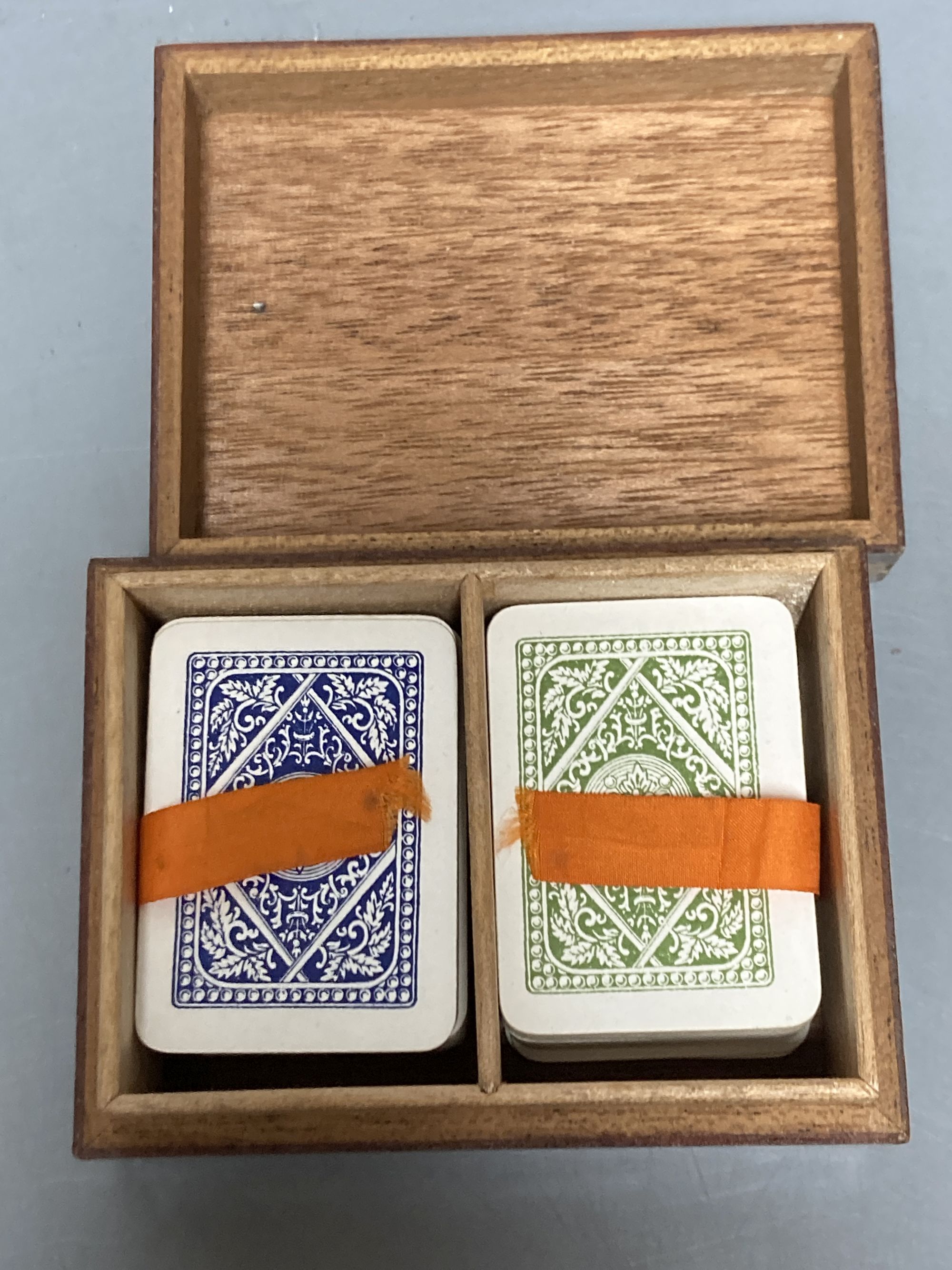 Four Tunbridge ware perspective cube marquetry small boxes, early 20th century, largest 12.2cm, one containing Goodall, London miniature playings cards (not checked if complete), 8.2cm and another with Thomas Barton inks